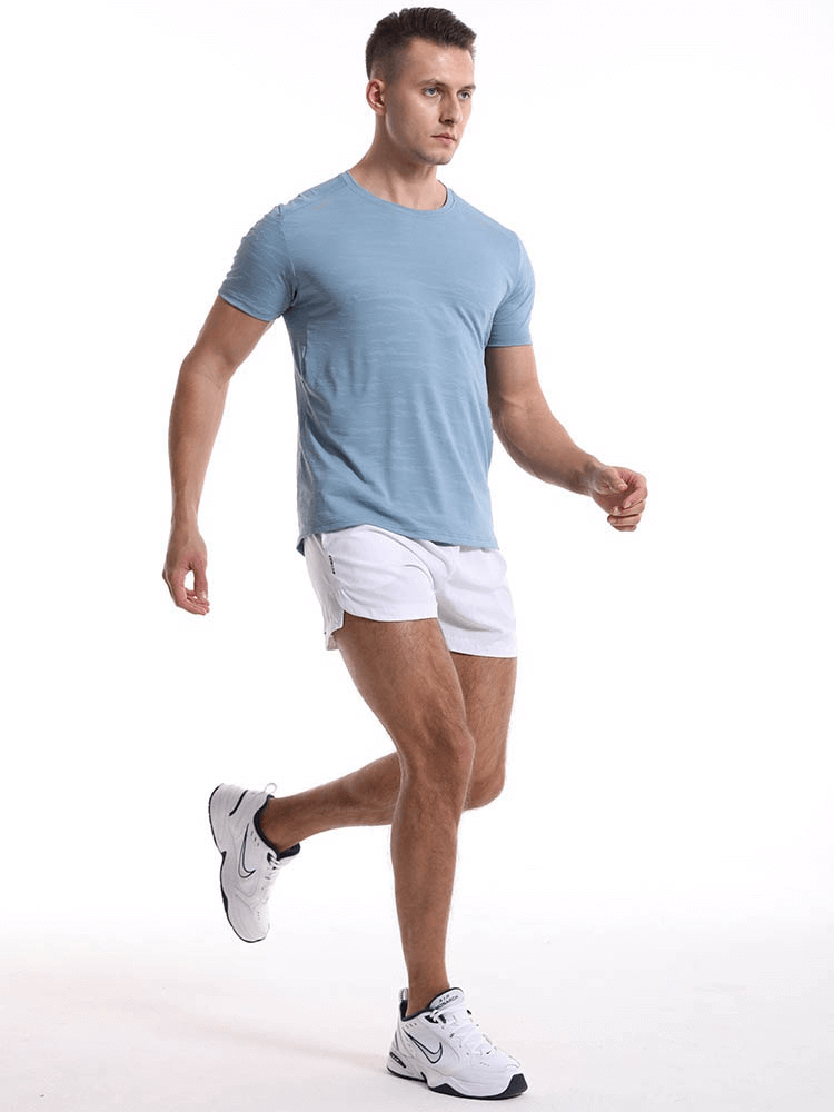 Man wearing Casual Short Sleeves Basketball Elastic T-shirt for Men SF1043 in light blue, ideal for running and sports.